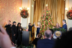 Carter and the first partner Jennifer Newsom celebrate the tree lighting with a double high five